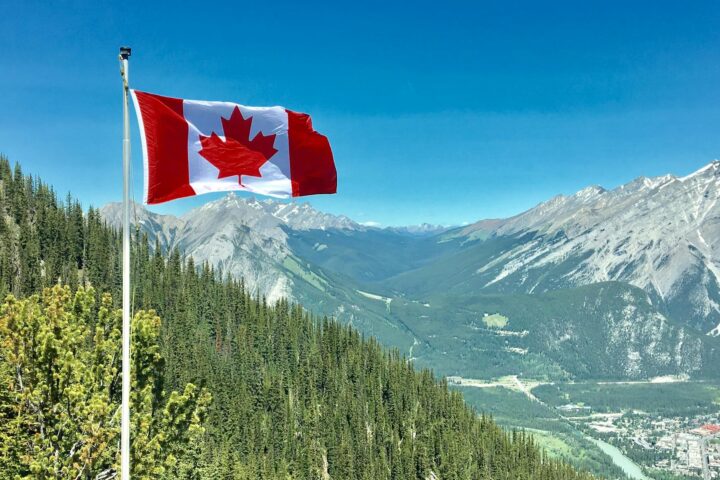 canada flag with mountain range view
