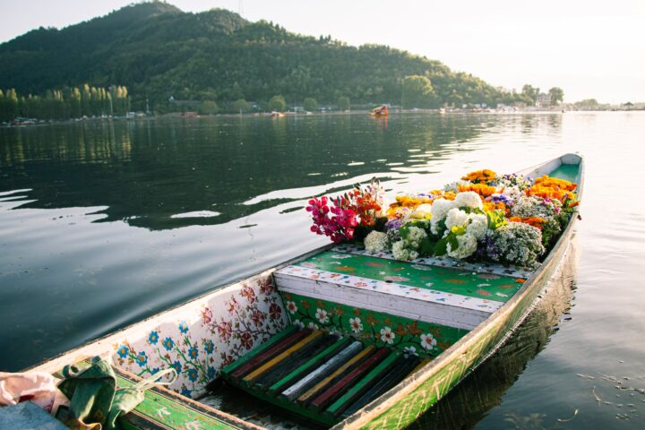 a wooden flower boat on dal lake