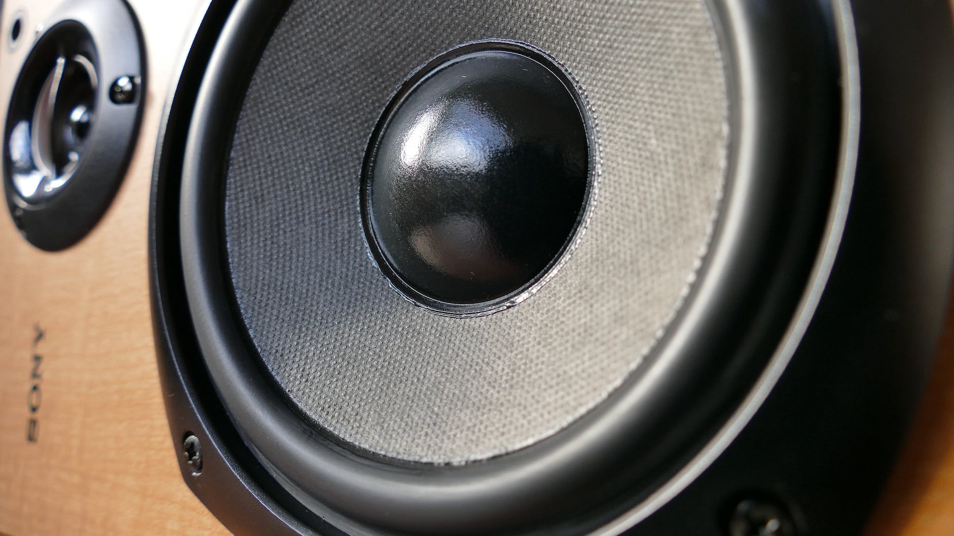 closed up photography of brown wooden framed sony speaker