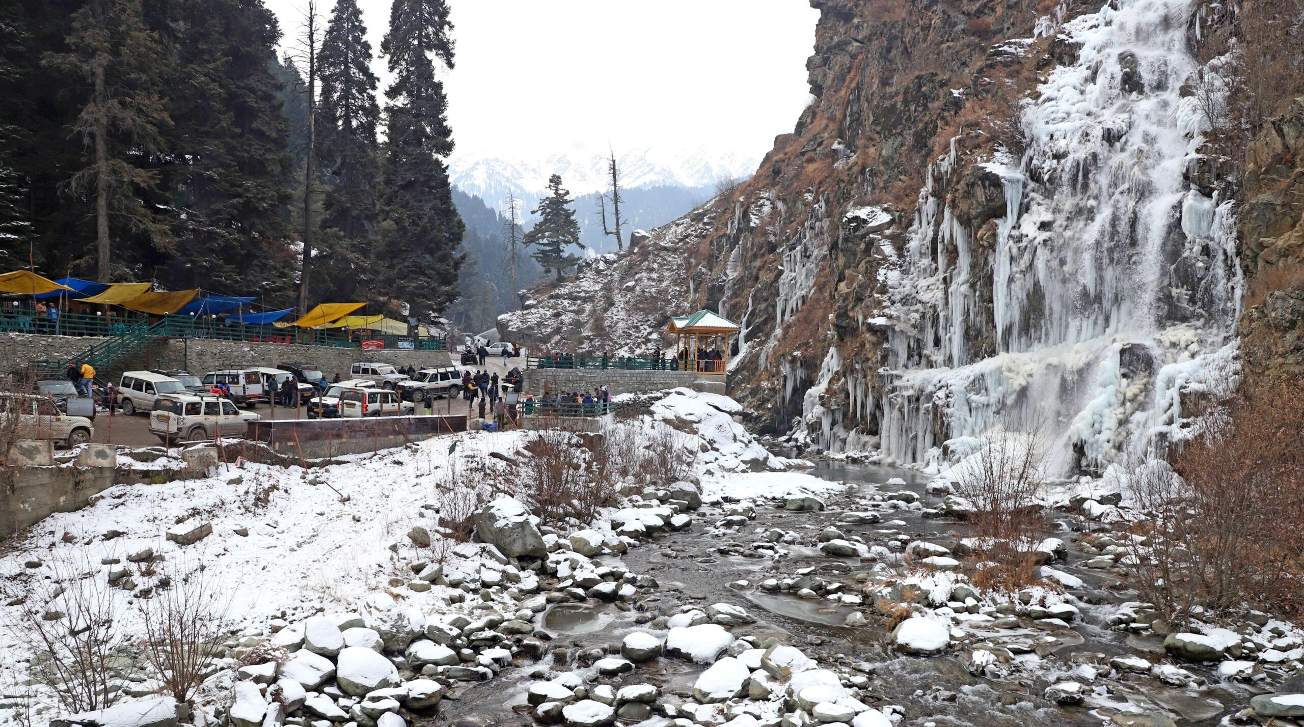 Kashmir Tourists and locals enjoying near the frozen waterfall formed due to sub zero temperatures in the Valley at Drung area of Tangmarg Umar Ganie 8 scaled